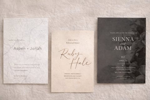 Three wedding invitation cards displayed on a textured beige background, featuring minimalist designs with couple names and event details